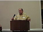 Ed Hovatter at the podium, discussing the Ship's Store