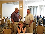 Ken Lollman and Glendon Chester, with Heather Stream looking just a tad bored sitting at the table