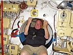 Todd Fowler crawling through a small hatch on the Russiansubmarine