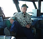 Marty Komarek in the captains chair aboard the Midway