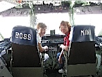 Kathy Davis sitting in the boss's chair, and Pat Dege in the Mini