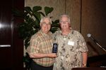 JJ Hogue presenting Tom bernard with a plaque for his outstanding work as President for the past four years